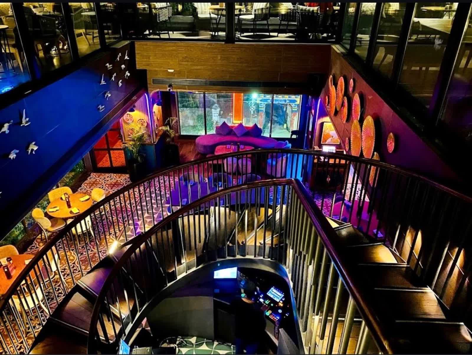 Spiral staircase in the Farzi Café Dehradun interior