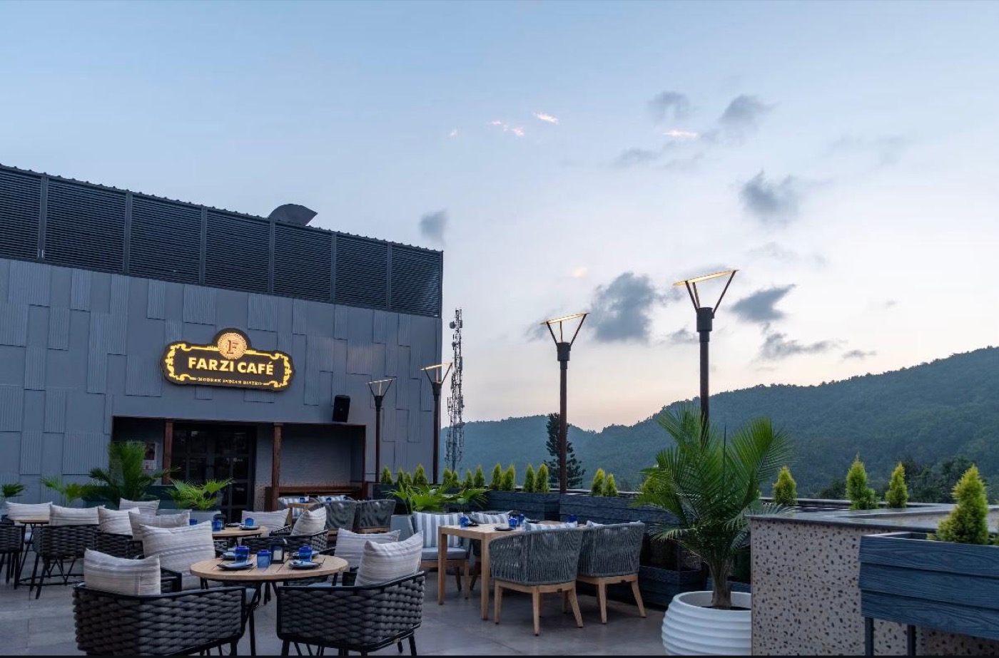 Rooftop terrace seating in daylight with mountain backdrop