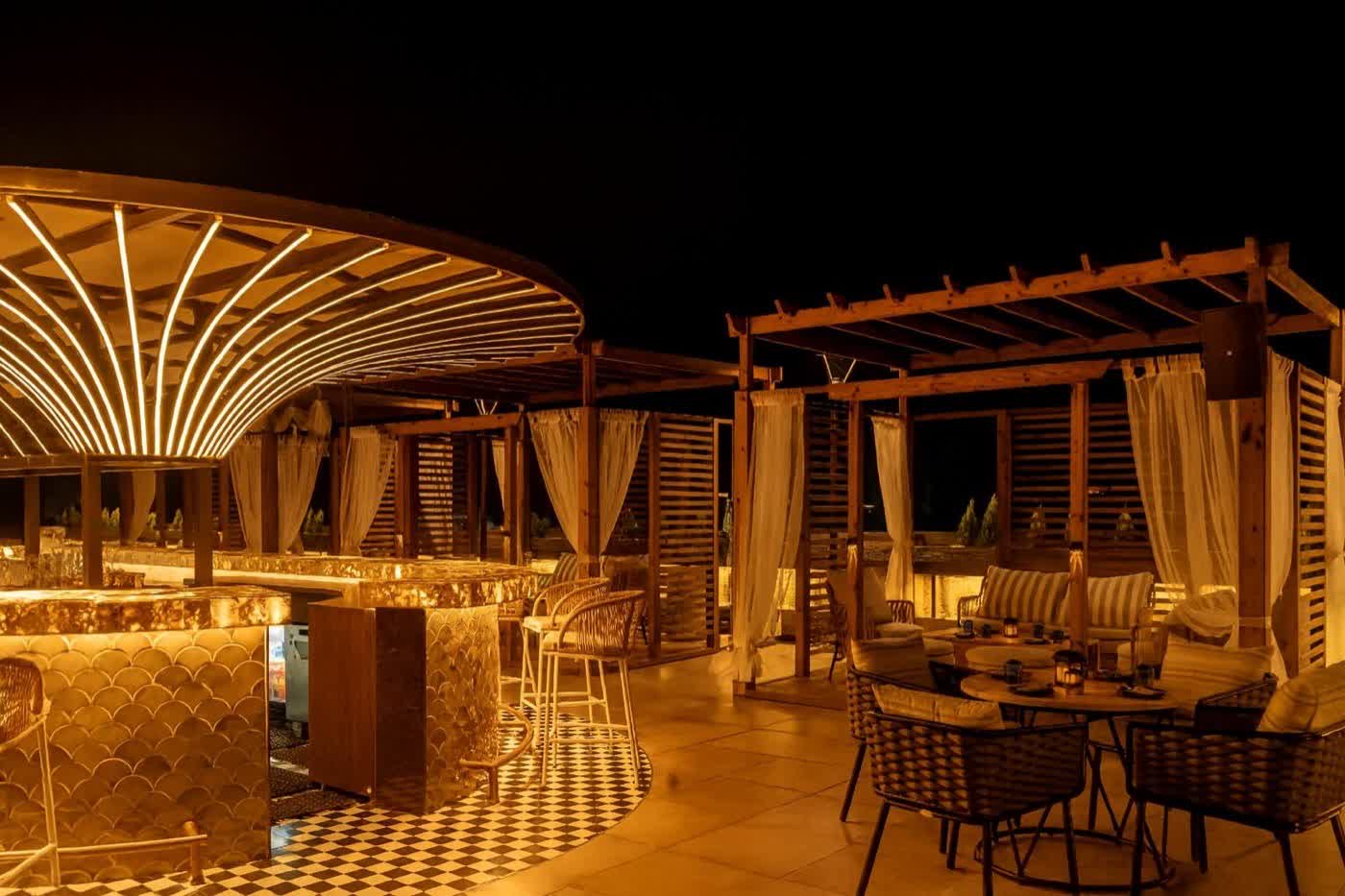 Wide view of terrace and cabanas at night