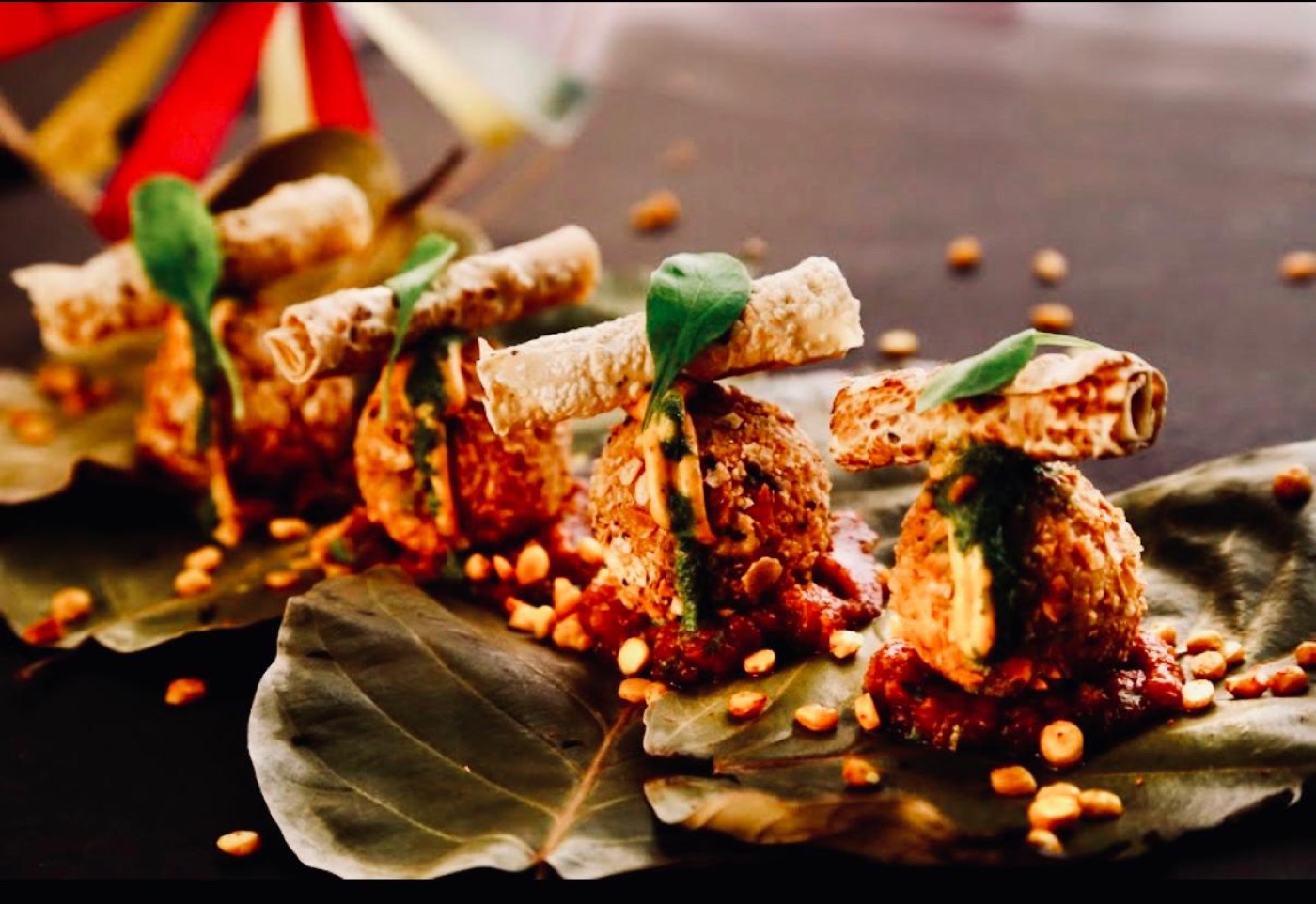 Croquettes plated on leaves with chutney